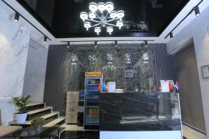 a store with a chandelier above a counter with stairs at Hayot Plaza Hotel in Yunusobod