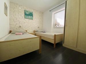 a bedroom with two beds and a window at Elegant Apartment in Vodice - 53 m² - Near the Sea in Vodice