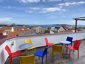 a group of colorful chairs and tables on a roof at Elegant Apartment in Vodice - 53 m² - Near the Sea in Vodice
