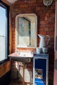 a bathroom with a sink and a brick wall at Destinesia Jason Works in Loughborough