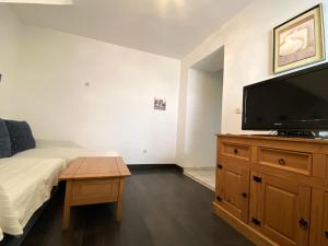 a bedroom with a bed and a flat screen tv at Enchanting Apartment in Vodice with Sea View Terrace in Vodice