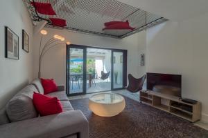a living room with a couch and a coffee table at One bedroom loft marina Anse Marcel in Cul de Sac