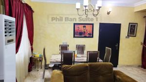 a dining room with a table and a chandelier at PhilBan Suites 1 in Ikeja