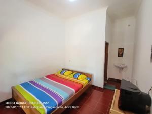 Ein Bett oder Betten in einem Zimmer der Unterkunft Pondok Galang