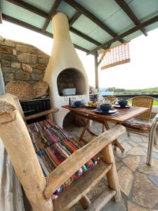 an outdoor kitchen with an oven with a table at Wood & Stone - Paros in Aspro Chorio Paros
