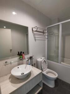 a white bathroom with a sink and a toilet at Rustic one bedroom unit for 4 pax with Sea View by JoMy Homestay in Lumut