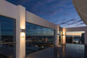 a building with a view of a city at night at Rydges Auckland in Auckland
