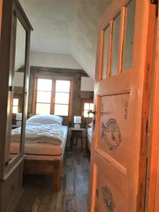 a bedroom with a bed and a wooden door at Fischerhus Lütt Hauke 75 qm Annerose in Altwarp