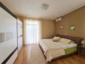 ein Schlafzimmer mit einem Bett und einem großen Fenster in der Unterkunft Holiday Home Drago in Zadar