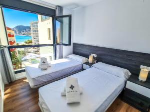 Postel nebo postele na pokoji v ubytování AVANOA - Arenal Suites Calpe