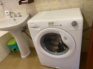 a washing machine in a bathroom next to a sink at Martin in Trento +18 photos
