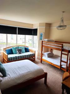 a bedroom with two beds and a bunk bed at St Breca in Newquay +19 photos