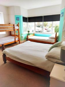 a bedroom with two beds and a window at St Breca in Newquay