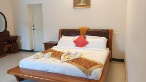 a bedroom with a bed with towels on it at Hotel Aradhana Inn in Yercaud