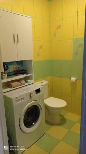 a bathroom with a washing machine and a toilet at Marina Apartments in Kołobrzeg