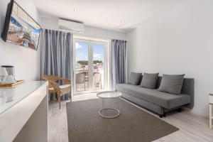 a living room with a couch and a table at Hotel Baltum in Albufeira