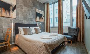 a bedroom with a bed with two towels on it at Thon Partner Hotel Kungsbron in Stockholm