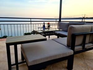 a balcony with two chairs and a table with a view of the ocean at Apartments Lusi in Brela