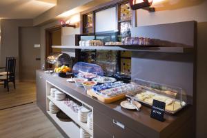 a buffet line with food on display in a restaurant at Alevic Hotel Sirmione in Sirmione