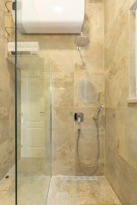a bathroom with a shower with a glass door at Kenova apartment Old Town in Dubrovnik