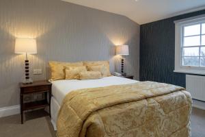 a bedroom with a bed and a lamp at The Clarendon Hotel in London