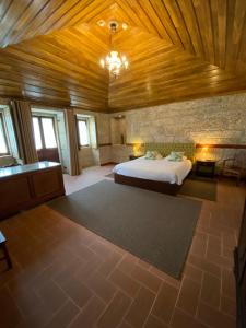 a bedroom with a bed and a wooden ceiling at Quinta Casa da Fonte in Vieira do Minho