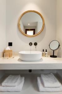 a bathroom with a white sink and a mirror at Le Mirage in Bormes-les-Mimosas