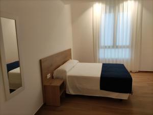 Łóżko lub łóżka w pokoju w obiekcie Iberflat Apartamentos Trinidad
