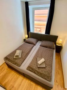 a large bed in a room with a window at Apartment Katrin im Zentrum in Bad Ischl +16 photos