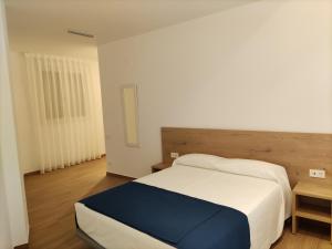 Łóżko lub łóżka w pokoju w obiekcie Iberflat Apartamentos Trinidad