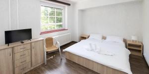 Rúm í herbergi á Hotel Fit Fun