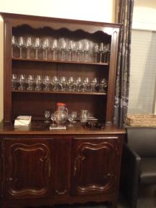 a large wooden cabinet with glasses on it at Het Herenhuis in Poroszló