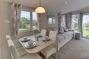 a living room with a table and a couch at The Lakes Rookley in Rookley