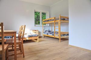 Pokój z 2 łóżkami piętrowymi i biurkiem w obiekcie Farma Serock w Serocku