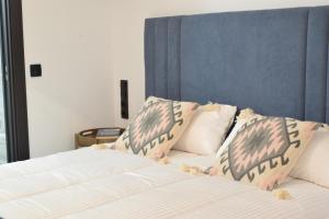 a bed with two pillows on top of it at Casa Rural La Lerena in Casar de Cáceres
