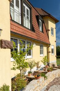 a yellow house with a red roof at Privatweingut Schmidt in Heitersheim +13 photos