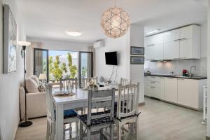 a kitchen and living room with a table and chairs at Alegria in Puerto del Carmen