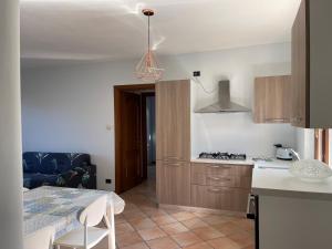 a kitchen with a table and a stove top oven at Lake Iseo - Gli ulivi 1 in Sulzano