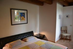 a bedroom with a bed and a picture on the wall at Apartment Magalita in Udine +11 photos