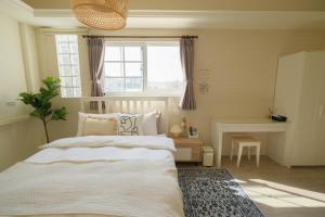a bedroom with a large bed and a window at Anping island in Anping