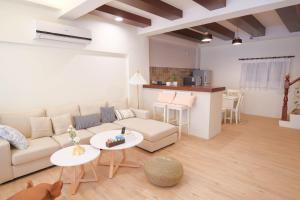 a living room with a couch and tables and a kitchen at Anping island in Anping