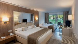 a hotel room with two beds and a television at Tour Khalef in Sousse