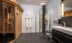 a bathroom with a shower, sink, and toilet at Thon Partner Hotel Kungsbron in Stockholm