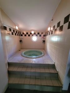 a bathroom with a tub in the middle of a room at A 500 mètres des plages et du port du brusc, Les terrasses des embiez avec piscine et spa in Six-Fours-les-Plages +5 photos