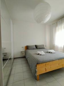a bedroom with a bed with two towels on it at Apartment in Sardinia in Decimomannu