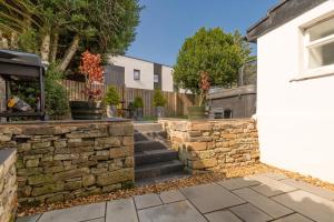 a stone retaining wall and stairs outside a house at Newly Renovated early 19th Century Cottage with Hot-Tub in Musselburgh