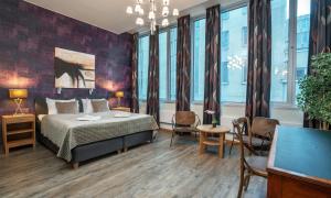 a bedroom with a bed and a table and chairs at Thon Partner Hotel Kungsbron in Stockholm