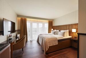 Säng eller sängar i ett rum på WIDE Hotel