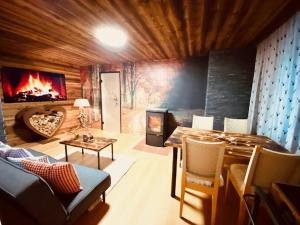 a living room with a couch and a fireplace at Wilderer Suiten Mariazell in Mariazell