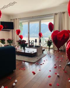 a living room with red hearts on the floor and balloons at Superbe Appartement avec vue sur le Lac du Bourget in Tresserves